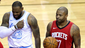 HOUSTON, TEXAS - JANUARY 10: LeBron James #23 of the Los Angeles Lakers reacts ahead of P.J. Tucker #17 of the Houston Rockets during the second quarter of a game at Toyota Center on January 10, 2021 in Houston, Texas. NOTE TO USER: User expressly acknowledges and agrees that, by downloading and or using this photograph, User is consenting to the terms and conditions of the Getty Images License Agreement. (Photo by Carmen Mandato/Getty Images)