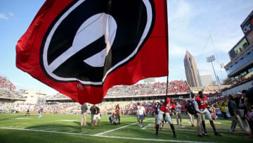 Nov 28, 2015; Atlanta, GA, USA; Georgia Bulldogs linebacker Jordan Jenkins (59) celebrates while waving the Georgia flag after their game against the Georgia Tech Yellow Jackets at Bobby Dodd Stadium. The Bulldogs won 13-7. Mandatory Credit: Jason Getz-USA TODAY Sports