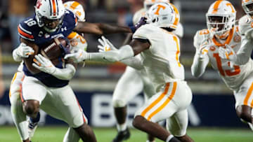 Auburn wide receiver Seth Williams (18) drags defenders for a few extra yards at Jordan-Hare Stadium in Auburn, Ala., on Saturday, Nov. 21, 2020. Auburn and Tennessee are tied 10-10 at halftime.