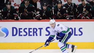 Mar 5, 2015; Glendale, AZ, USA; Vancouver Canucks right wing Radim Vrbata (17) skates the puck by the Arizona Coyotes bench at Gila River Arena. The Coyotes won 3-2 in a shootout. Mandatory Credit: Joe Camporeale-USA TODAY Sports