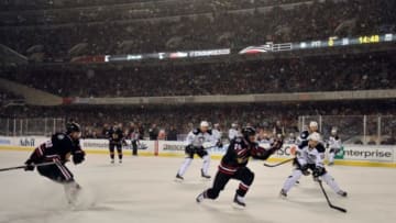 Mar 1, 2014; Chicago, IL, USA; Chicago Blackhawks left wing Brandon Saad (20) chases after the puck against Pittsburgh Penguins center Brandon Sutter (16) during the third period in a Stadium Series hockey game at Soldier Field. Mandatory Credit: Rob Grabowski-USA TODAY Sports
