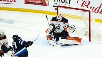 May 24, 2021; Winnipeg, Manitoba, CAN; Edmonton Oilers goalie Mike Smith (41) makes a save on a shot by Winnipeg Jets forward Nikolaj Ehlers (27) during the first overtime period in game four of the first round of the 2021 Stanley Cup Playoffs at Bell MTS Place. Mandatory Credit: Terrence Lee-USA TODAY Sports