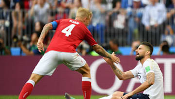 MOSCOW, RUSSIA - JUNE 26: Olivier Giroud of France is helped by Simon Kjaer of Denmark during the 2018 FIFA World Cup Russia group C match between Denmark and France at Luzhniki Stadium on June 26, 2018 in Moscow, Russia. (Photo by Matthias Hangst/Getty Images)