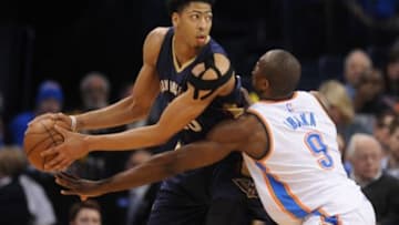 Feb 6, 2015; Oklahoma City, OK, USA; New Orleans Pelicans forward Anthony Davis (23) handles the ball against Oklahoma City Thunder forward Serge Ibaka (9) during the second quarter at Chesapeake Energy Arena. Mandatory Credit: Mark D. Smith-USA TODAY Sports
