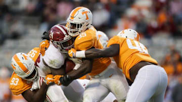 KNOXVILLE, TN - OCTOBER 20: Brian Robinson Jr. #24 of the Alabama Crimson Tide is tackled by Defensive lineman Emmit Gooden #93 of the Tennessee Volunteers, Linebacker Daniel Bituli #35 of the Tennessee Volunteers, and Linebacker Matt Ballard of the Tennessee Volunteers during the second half of the game between the Alabama Crimson Tide and the Tennessee Volunteers at Neyland Stadium on October 20, 2018 in Knoxville, Tennessee. (Photo by Donald Page/Getty Images)