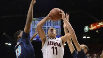 Mar 15, 2014; Las Vegas, NV, USA; Arizona Wildcats forward Aaron Gordon (11) drives to the basket against UCLA Bruins forward/center Tony Parker (23) and guard Zach LaVine (14) during the first half in the championship game of the Pac-12 Conference college basketball tournament at MGM Grand Garden Arena. Mandatory Credit: Kyle Terada-USA TODAY Sports