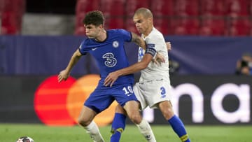 SEVILLE, SPAIN - APRIL 13: Christian Pulisic of Chelsea FC competes for the ball with Kepler Lima 'Pepe' of Porto during the UEFA Champions League Quarter Final Second Leg match between Chelsea FC and FC Porto at Estadio Ramon Sanchez Pizjuan on April 13, 2021 in Seville, Spain. Sporting stadiums around Spain remain under strict restrictions due to the Coronavirus Pandemic as Government social distancing laws prohibit fans inside venues resulting in games being played behind closed doors. (Photo by Jose Manuel Alvarez/Quality Sport Images/Getty Images)
