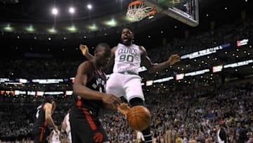 Mar 23, 2016; Boston, MA, USA; Boston Celtics forward Amir Johnson (90) reacts after dunking the ball in front of Toronto Raptors center Bismack Biyombo (8) during the second half at TD Garden. Mandatory Credit: Bob DeChiara-USA TODAY Sports