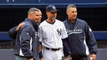 Apr 7, 2014; Bronx, NY, USA; New York Yankees former players Mariano Rivera (left to right) and Jorge Posada and Andy Pettitte talk with New York Yankees shortstop Derek Jeter (2) after the ceremonial first pitch before the start of an opening day game against the Baltimore Orioles at Yankee Stadium. Jeter announced in February that he will retire following this season. Mandatory Credit: Brad Penner-USA TODAY Sports