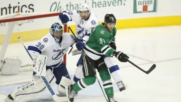 Mar 17, 2016; Dallas, TX, USA; Dallas Stars center Tyler Seguin (91) fights for the puck against Tampa Bay Lightning goalie Ben Bishop (30) and defenseman Braydon Coburn (55) in the third period at American Airlines Center. The Stars won 4-3. Mandatory Credit: Tim Heitman-USA TODAY Sports