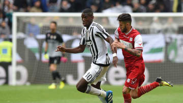 TURIN, ITALY - MAY 01: Paul Pogba (L) of Juventus FC is challenged by Marco Crimi of Carpi FC during the Serie A match between Juventus FC and Carpi FC at Juventus Arena on May 1, 2016 in Turin, Italy. (Photo by Valerio Pennicino/Getty Images)