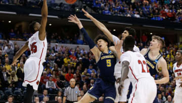 INDIANAPOLIS, IN - MARCH 19: D.J. Wilson #5 of the Michigan Wolverines attempts a shot against Donovan Mitchell #45, Anas Mahmoud #14 and Deng Adel #22 of the Louisville Cardinals in the first half during the second round of the 2017 NCAA Men's Basketball Tournament at the Bankers Life Fieldhouse on March 19, 2017 in Indianapolis, Indiana. (Photo by Joe Robbins/Getty Images)