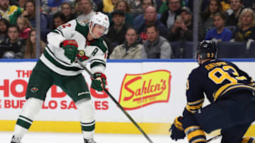 BUFFALO, NY - NOVEMBER 22: Eric Staal #12 of the Minnesota Wild takes a shot as Victor Antipin #93 of the Buffalo Sabres defends during the third period at the KeyBank Center on November 22, 2017 in Buffalo, New York. (Photo by Kevin Hoffman/Getty Images)
