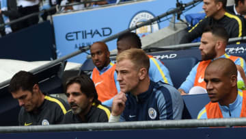 Manchester City's English goalkeeper Joe Hart (2R) sits on the substitutes bench for the English Premier League football match between Manchester City and Sunderland at the Etihad Stadium in Manchester, north west England, on August 13, 2016.Manchester City manager Pep Guardiola dropped goalkeeper Joe Hart in favour of Willy Caballero for his opening Premier League game against Sunderland on August 13. / AFP / PAUL ELLIS / RESTRICTED TO EDITORIAL USE. No use with unauthorized audio, video, data, fixture lists, club/league logos or 'live' services. Online in-match use limited to 75 images, no video emulation. No use in betting, games or single club/league/player publications. / (Photo credit should read PAUL ELLIS/AFP/Getty Images)