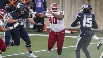 LOGAN, UT - NOVEMBER 14: Kevin Atkins #90 of the Fresno State Bulldogs rushes Jason Shelley #15 of the Utah State Aggies during their game November 14, 2020 at Maverick Stadium in Logan, Utah. (Photo by Chris Gardner/Getty Images)