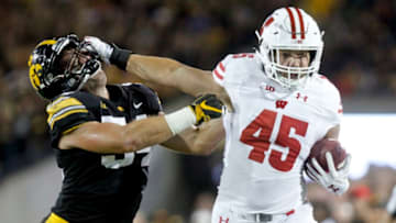 IOWA CITY, IOWA- SEPTEMBER 22: Fullback Alec Ingold #45 of the Wisconsin Badgers breaks a tackle in the first half by linebacker Kristian Welch #34 of the Iowa Hawkeyes on September 22, 2018 at Kinnick Stadium, in Iowa City, Iowa. (Photo by Matthew Holst/Getty Images)