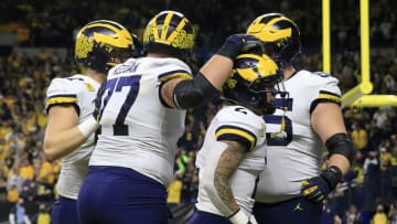 INDIANAPOLIS, INDIANA - DECEMBER 04: Blake Corum #2 of the Michigan Wolverines celebrates a touchdown with his team during the Big Ten Football Championship against the Iowa Hawkeyes at Lucas Oil Stadium on December 04, 2021 in Indianapolis, Indiana. (Photo by Justin Casterline/Getty Images)