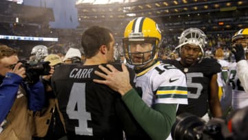 Dec 20, 2015; Oakland, CA, USA; Green Bay Packers quarterback Aaron Rodgers (12) meets with Oakland Raiders quarterback Derek Carr (4) after the game at O.co Coliseum. The Packers defeated the Raiders 30-20. Mandatory Credit: Cary Edmondson-USA TODAY Sports