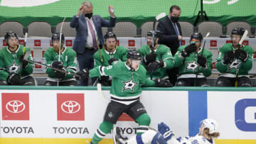 DALLAS, TEXAS - MARCH 25: Rhett Gardner #49 of the Dallas Stars checks Mikhail Sergachev #98 of the Tampa Bay Lightning in the first period at American Airlines Center on March 25, 2021 in Dallas, Texas. (Photo by Tom Pennington/Getty Images)