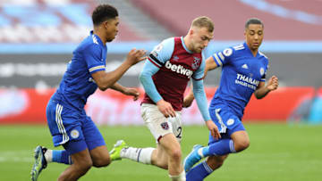 LONDON, ENGLAND - APRIL 11: Jarrod Bowen of West Ham United is tackled by (L-R) Wesley Fofana and Youri Tielemans of Leicester City during the Premier League match between West Ham United and Leicester City at London Stadium on April 11, 2021 in London, England. Sporting stadiums around the UK remain under strict restrictions due to the Coronavirus Pandemic as Government social distancing laws prohibit fans inside venues resulting in games being played behind closed doors. (Photo by Julian Finney/Getty Images)