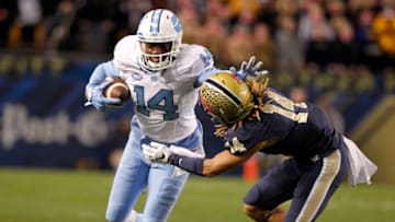 PITTSBURGH, PA - OCTOBER 29: Quinshad Davis #14 of the North Carolina Tar Heels stiff arms Avonte Maddox #14 of the Pittsburgh Panthers in the first half during the game on October 29, 2015 at Heinz Field in Pittsburgh, Pennsylvania. (Photo by Justin K. Aller/Getty Images)