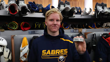 BUFFALO, NY - OCTOBER 11: Rasmus Dahlin of the Buffalo Sabres holds the puck from his first NHL point following a game against the Colorado Avalanche on October 11, 2018 at KeyBank Center in Buffalo, New York. (Photo by Bill Wippert/NHLI via Getty Images)