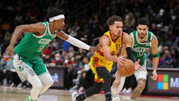 Jan 28, 2022; Atlanta, Georgia, USA; Atlanta Hawks guard Trae Young (11) drives past Boston Celtics guard Josh Richardson (8) and forward Jayson Tatum (0) in the second quarter at State Farm Arena. Mandatory Credit: Brett Davis-USA TODAY Sports