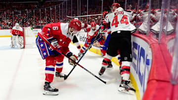 WASHINGTON, DC - JANUARY 11: Miles Wood #44 of the New Jersey Devils checks Richard Panik #14 of the Washington Capitals in the second period at Capital One Arena on January 11, 2020 in Washington, DC. (Photo by Patrick McDermott/NHLI via Getty Images)