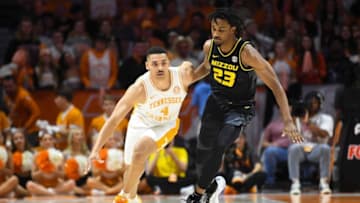 Tennessee guard Tyreke Key (4) dribbles toward the basket while defended by Missouri forward Aidan Shaw (23) during an NCAA college basketball game between the Missouri Tigers and the Tennessee Volunteers in Thompson-Boling Arena in Knoxville, Saturday Feb. 11, 2023.Tennesseemissouri0211 0564