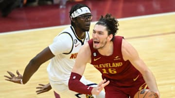 Feb 23, 2023; Cleveland, Ohio, USA; Denver Nuggets guard Reggie Jackson (7) defends Cleveland Cavaliers forward Cedi Osman (16) in the fourth quarter at Rocket Mortgage FieldHouse. Mandatory Credit: David Richard-USA TODAY Sports
