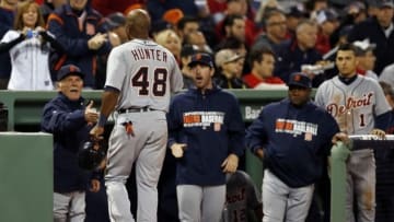 Oct 19, 2013; Boston, MA, USA; Detroit Tigers right fielder Torii Hunter (48) is congratulated after scoring a run against the Boston Red Sox during the sixth inning in game six of the American League Championship Series playoff baseball game at Fenway Park. Mandatory Credit: Greg M. Cooper-USA TODAY Sports