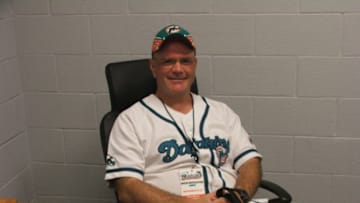 Brian Miller sitting at the coaches desk in the Dolphins locker room at the stadium - 2007