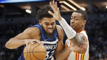 Minnesota Timberwolves center Karl-Anthony Towns tries to get around Atlanta Hawks forward John Collins. Mandatory Credit: Bruce Kluckhohn-USA TODAY Sports