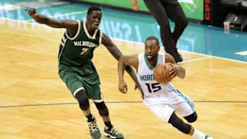 CHARLOTTE, UNITED STATES - MARCH 28: Kemba Walker (15) of Charlotte Hornets passes Thon Maker of Milwaukee Bucks during the NBA match between Milwaukee Bucks vs Charlotte Hornets at the Spectrum arena in Charlotte, NC, USA on March 28, 2017. (Photo by Peter Zay/Anadolu Agency/Getty Images)