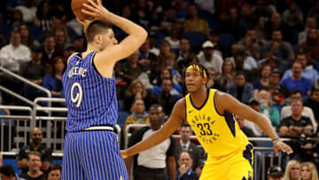 ORLANDO, FLORIDA - DECEMBER 07: Nikola Vucevic #9 of the Orlando Magic looks to make a pass against Myles Turner #33 of the Indiana Pacers during the game at Amway Center on December 07, 2018 in Orlando, Florida. NOTE TO USER: User expressly acknowledges and agrees that, by downloading and or using this photograph, User is consenting to the terms and conditions of the Getty Images License Agreement. (Photo by Sam Greenwood/Getty Images)