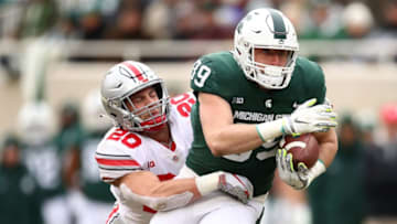 EAST LANSING, MI - NOVEMBER 10: Matt Dotson #89 of the Michigan State Spartans battles for yards after a second half catch while being tackled by Pete Werner #20 of the Ohio State Buckeyes at Spartan Stadium on November 10, 2018 in East Lansing, Michigan. (Photo by Gregory Shamus/Getty Images)