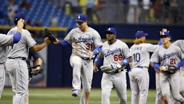 May 3, 2016; St. Petersburg, FL, USA; Los Angeles Dodgers center fielder Joc Pederson (31), right fielder Yasiel Puig (66) and teammates congratulate each other as they beat the Tampa Bay Rays at Tropicana Field. Los Angeles Dodgers defeated the Tampa Bay Rays 10-5. Mandatory Credit: Kim Klement-USA TODAY Sports