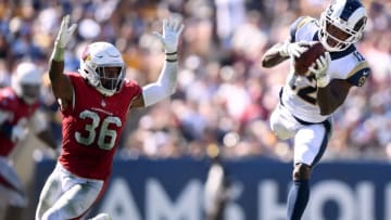 LOS ANGELES, CA - SEPTEMBER 16: Brandin Cooks #12 of the Los Angeles Rams makes a jumping catch for a first down in front of Budda Baker #36 of the Arizona Cardinals during the fourth quarter at Los Angeles Memorial Coliseum on September 16, 2018 in Los Angeles, California. (Photo by Harry How/Getty Images)