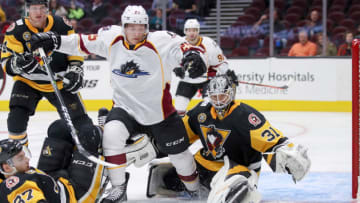 CLEVELAND, OH - OCTOBER 11: Cleveland Monsters center Alex Broadhurst (25) collides with Wilkes-Barre/Scranton Penguins goalie Anthony Peters (31) as he chases the loose puck during the second period of the American Hockey League game between the Wilkes-Barre/Scranton Penguins and Cleveland Monsters on October 11, 2018, at Quicken Loans Arena in Cleveland, OH. Wilkes-Barre/Scranton defeated Cleveland 3-0. (Photo by Frank Jansky/Icon Sportswire via Getty Images)