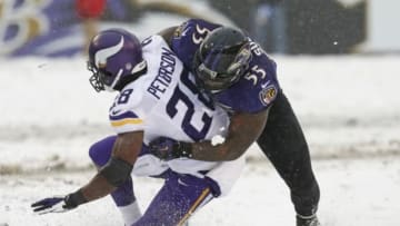 Dec 8, 2013; Baltimore, MD, USA; Minnesota Vikings running back Adrian Peterson (28) tackled by Baltimore Ravens linebacker Terrell Suggs (55) at M&T Bank Stadium. Mandatory Credit: Mitch Stringer-USA TODAY Sports