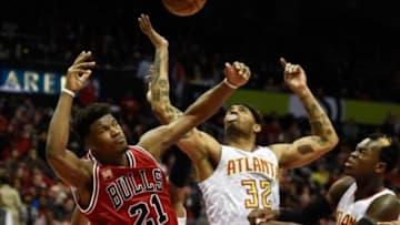 Jan 9, 2016; Atlanta, GA, USA; Chicago Bulls guard Jimmy Butler (21) battles with Atlanta Hawks forward Mike Scott (32) for a rebound during the second half at Philips Arena. The Hawks defeated the Bulls 120-105. Mandatory Credit: Dale Zanine-USA TODAY Sports