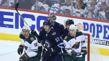 WINNIPEG, MANITOBA - APRIL 11: Jordan Greenway #18 and Charlie Coyle #3 of the Minnesota Wild crowd the Winnipe goal in front of Tyler Myers #57, Ben Chiarot #7 and Connor Hellebuyck #37 of the Winnipeg Jets in Game One of the Western Conference First Round during the 2018 NHL Stanley Cup Playoffs on April 11, 2018 at Bell MTS Place in Winnipeg, Manitoba, Canada. (Photo by Jason Halstead /Getty Images) *** Local Caption *** Jordan Greenway; Charlie Coyle; Tyler Myers; Ben Chiarot; Connor Hellebuyck