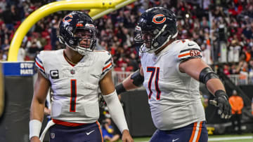 Nov 20, 2022; Atlanta, Georgia, USA; Chicago Bears quarterback Justin Fields (1) reacts with offensive tackle Riley Reiff (71) after running for a touchdown against the Atlanta Falcons at Mercedes-Benz Stadium. Mandatory Credit: Dale Zanine-USA TODAY Sports