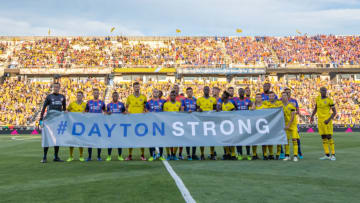 COLUMBUS, OH - AUGUST 10: FC Cincinnati and Columbus Crew SC teams pose for a photo with a #DAYTONSTONG banner before the MLS regular season game between the Columbus Crew SC and FC Cincinnati on August 10, 2019 at Mapfre Stadium in Columbus, OH. (Photo by Adam Lacy/Icon Sportswire via Getty Images)