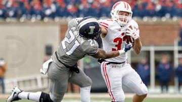 CHAMPAIGN, IL - OCTOBER 28: Garrett Groshek #37 of the Wisconsin Badgers runs the ball and delivers the stiff arm to Patrick Nelson #21 of the Illinois Fighting Illini at Memorial Stadium on October 28, 2017 in Champaign, Illinois. (Photo by Michael Hickey/Getty Images)