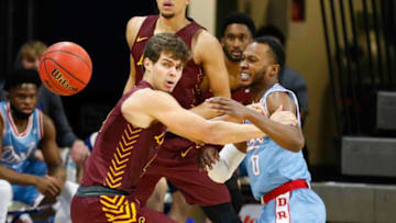 Drake junior guard D.J. Wilkins, right, knocks the ball away from Loyola's Braden Norris in the first half on Saturday, Feb. 13, 2021, at the Knapp Center in Des Moines.20210213 Drakevsloyola