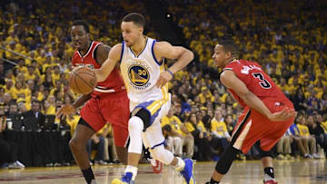 May 11, 2016; Oakland, CA, USA; Golden State Warriors guard Stephen Curry (30) dribbles the basketball against Portland Trail Blazers center Ed Davis (17) and guard C.J. McCollum (3) during the third quarter in game five of the second round of the NBA Playoffs at Oracle Arena. The Warriors defeated the Trail Blazers 125-121. Mandatory Credit: Kyle Terada-USA TODAY Sports