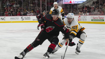 Jan 14, 2023; Raleigh, North Carolina, USA; Carolina Hurricanes right wing Andrei Svechnikov (37) tries to carry the puck past Pittsburgh Penguins defenseman Mark Friedman (52) during the third period at PNC Arena. Mandatory Credit: James Guillory-USA TODAY Sports