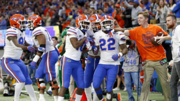 ATLANTA, GEORGIA - DECEMBER 29: Lamical Perine #22 of the Florida Gators is congratulated by his teammates after scoring a fourth quarter rushing touchdown against the Michigan Wolverines during the Chick-fil-A Peach Bowl at Mercedes-Benz Stadium on December 29, 2018 in Atlanta, Georgia. (Photo by Mike Zarrilli/Getty Images)