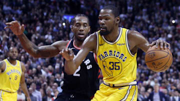 TORONTO, ON - NOVEMBER 29: Kevin Durant #35 of the Golden State Warriors dribbles the ball as Kawhi Leonard #2 of the Toronto Raptors defends during the second half of an NBA game at Scotiabank Arena on November 29, 2018 in Toronto, Canada. NOTE TO USER: User expressly acknowledges and agrees that, by downloading and or using this photograph, User is consenting to the terms and conditions of the Getty Images License Agreement. (Photo by Vaughn Ridley/Getty Images)